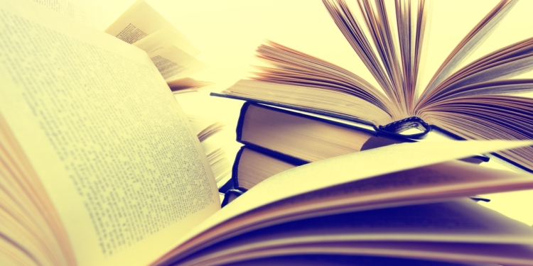 Paper hardback books laying open